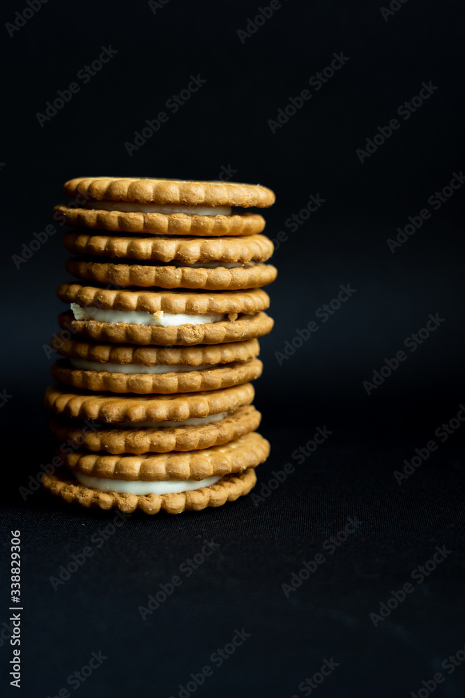 A pile of cookies on dark black background, side view A pile of cookies on dark black background, side view