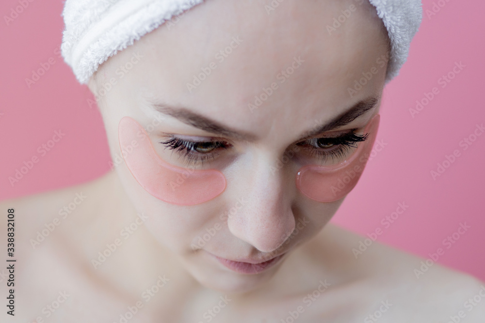 Portrait of Beauty Woman with Eye Patches on pink background. Woman Beauty Face with Mask under Eyes. Skin care, cosmetic product concept Portrait of Beauty Woman with Eye Patches on pink background. Woman Beauty Face with Mask under Eyes. Skin care, cosmetic product concept