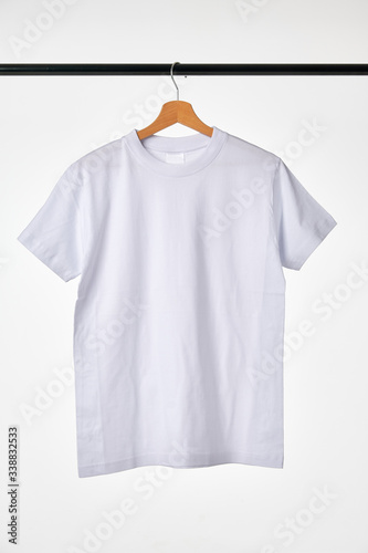 Blank White T-Shirt Mock-up hanging on white background. 