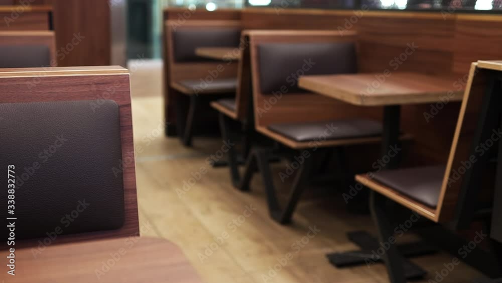 Empty food court interior. Commercial cafe furniture. Wooden tables in a restaurant. Empty food court interior. Commercial cafe furniture. Wooden tables in a restaurant.