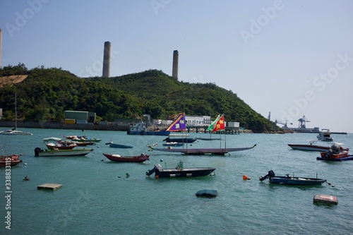 Lamma Island, Hong Kong - 12 April 2020 : Weekend travel capture, landscape of the coast next to Yung Shue Wan ferry pier at the island north, boat flowing next by. photo