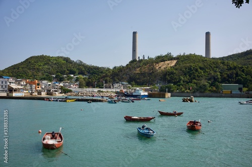 Lamma Island, Hong Kong - 12 April 2020 : Weekend travel capture, landscape of the coast next to Yung Shue Wan ferry pier at the island north, boat flowing next by.