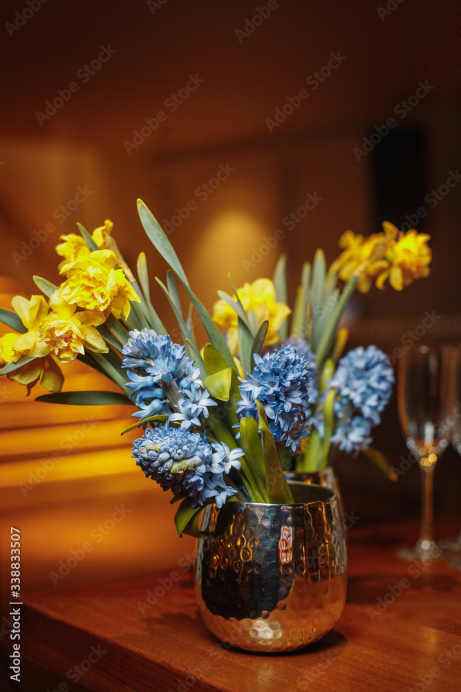 vase with bouquet of flowers on table in restaurant
