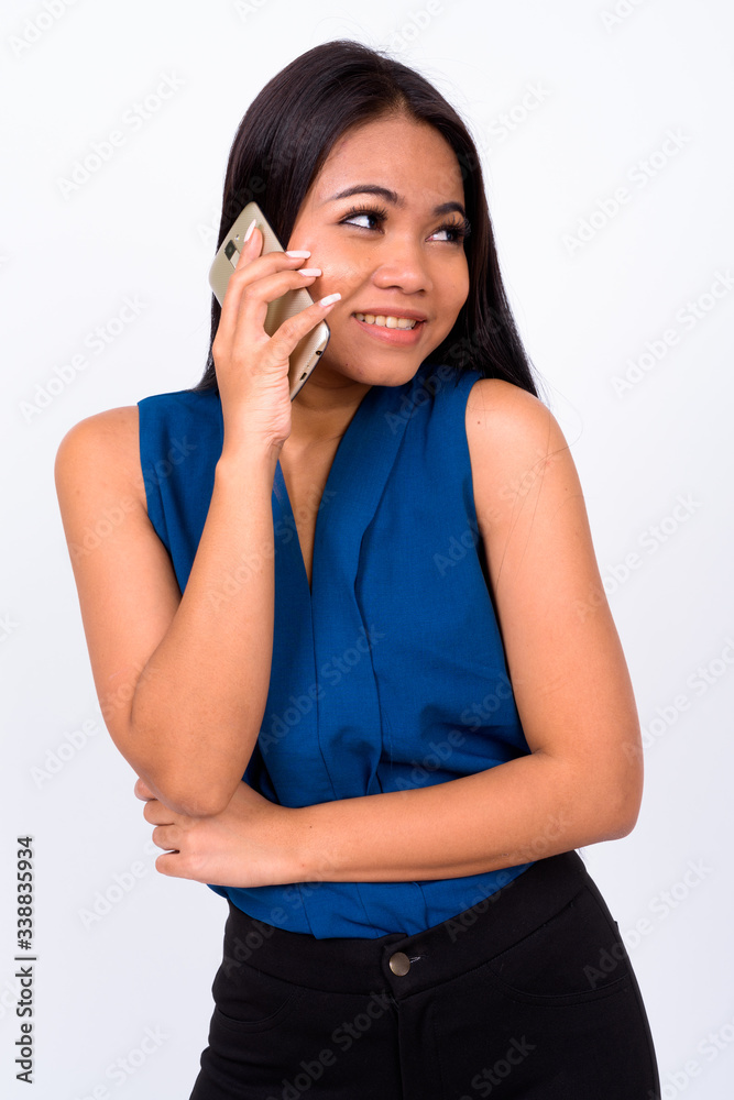 Portrait of happy young Asian businesswoman talking on the phone Portrait of happy young Asian businesswoman talking on the phone