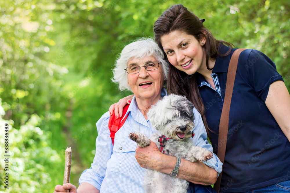 Happy Family with  Dog in the Summer Park .Family Portrait of Grandmother and Granddaughter with Dog