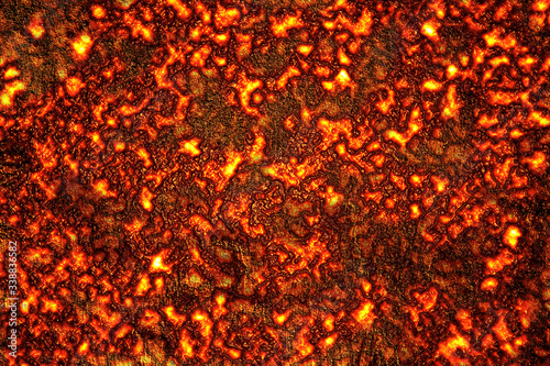 The texture of the hot lava. Red yellow trendy background. Hot stones from a volcano. Streams of molten rock. Trendy graphic drawing.