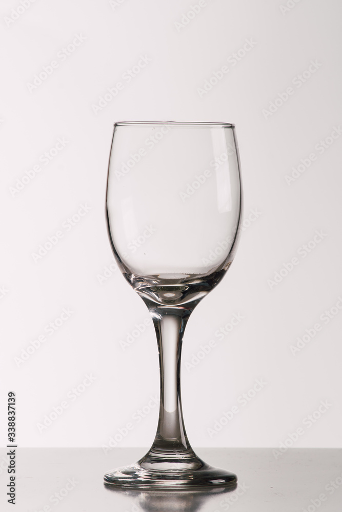 Empty wine glass on a grey background. Empty wine glass on a grey background.