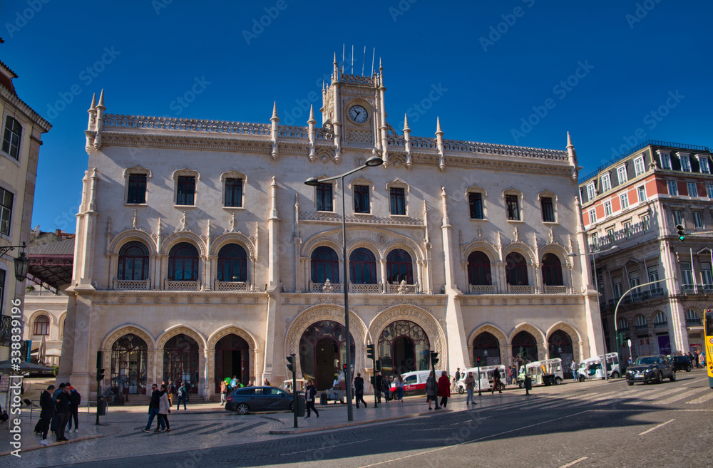 People in front of the entrance to Rossio train station. Former central railway station, it was opened in 1891 and connected the city with the region of Sintra