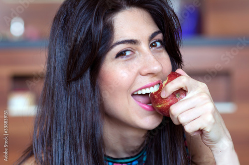 Portrait of a Beautiful Young Woman Eating Red Apple.Healthy Eating