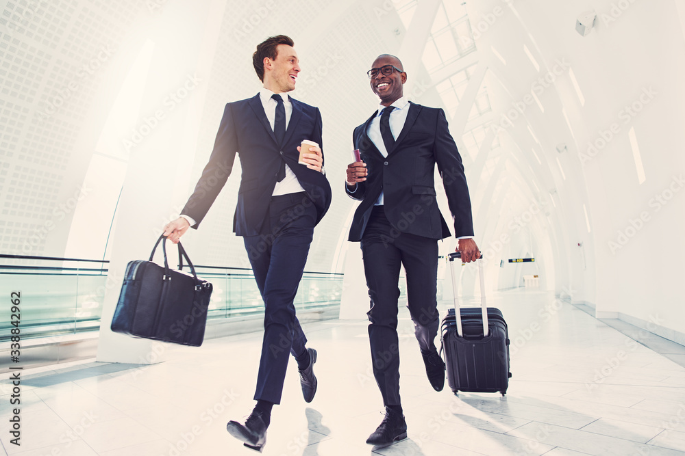 Smiling businessman rushing through an airport late for a flight Smiling businessman rushing through an airport late for a flight