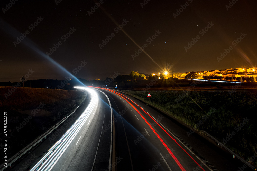 Car light trails in a road