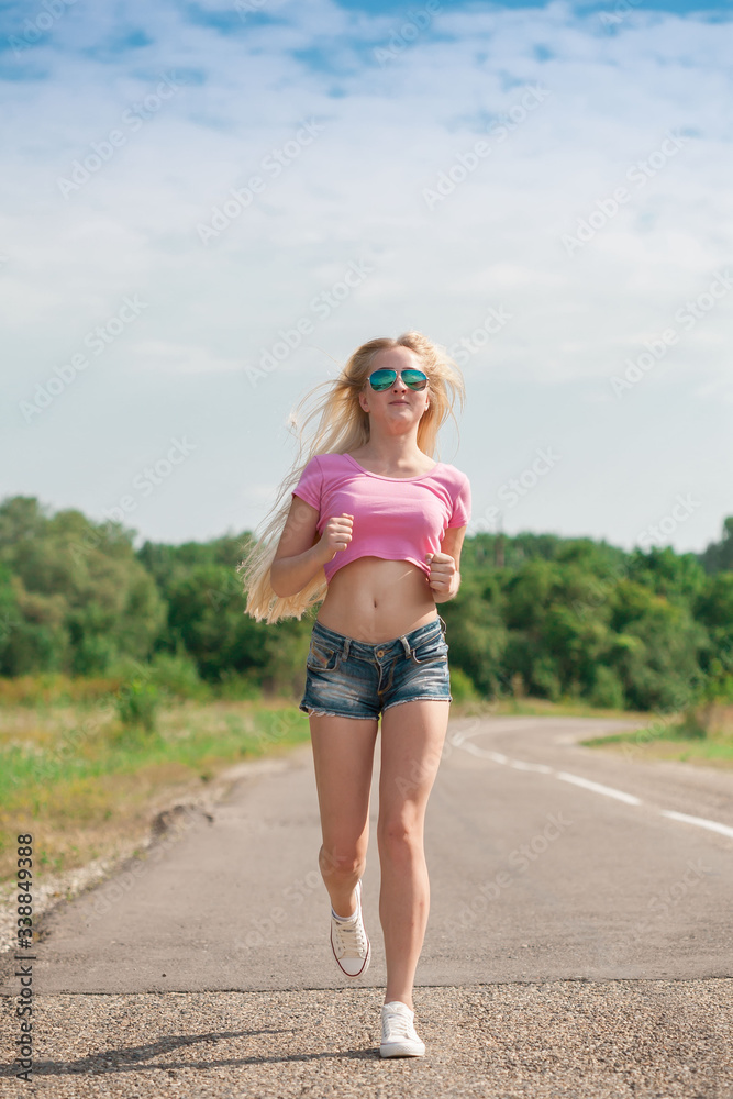 Girl, sunglasses, jeans, pink t-shirt, run in road Girl, sunglasses, jeans, pink t-shirt, run in road