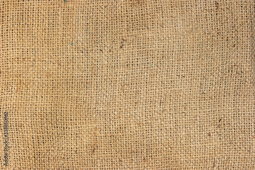 Brown sackcloth texture surface background with copy space for wallpaper backdrop. Close up background of natural brown fabric sack weaving is a bag for packing