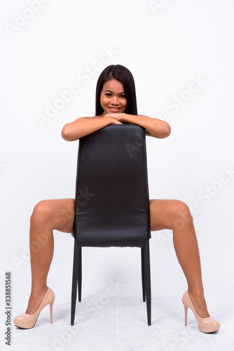 Young Asian woman wearing swimwear against white background © Ranta Images