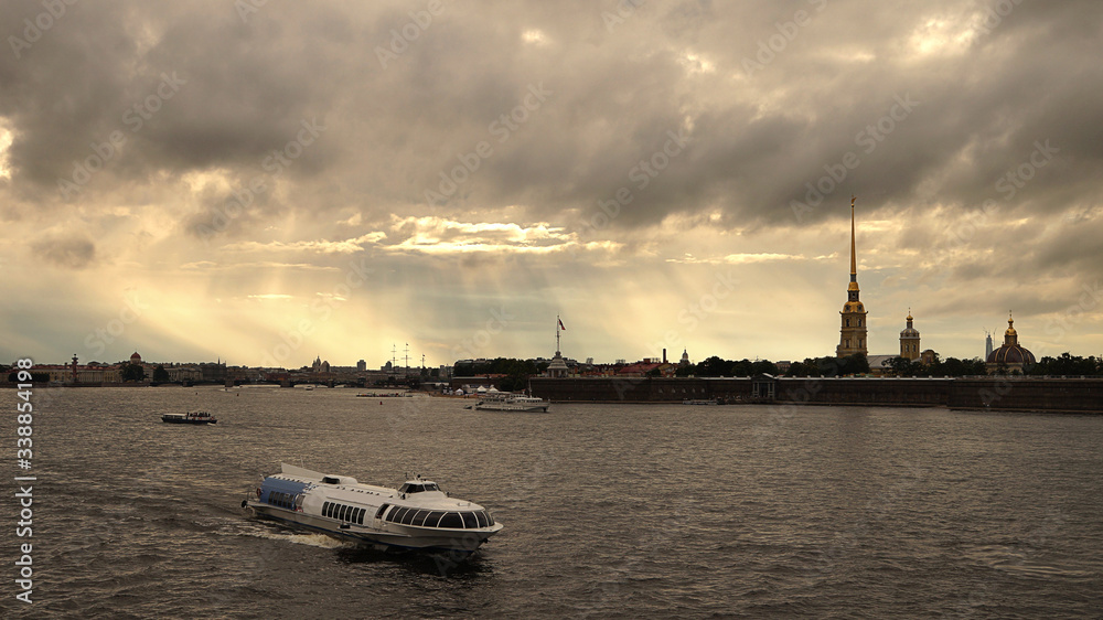 View of the Neva river with tourist pleasure boats at sunset in the city of St. Petersburg in Russia