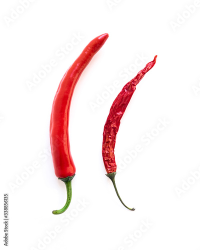 two red hot peppers of different ages isolated on a white background. Concept of potency and men's health and strength.