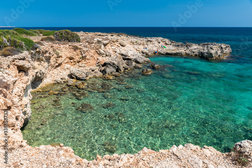 Rocky coastline and transparent water at punta Asparano, near Siracusa, during the summer (Sicily, Italy) photo