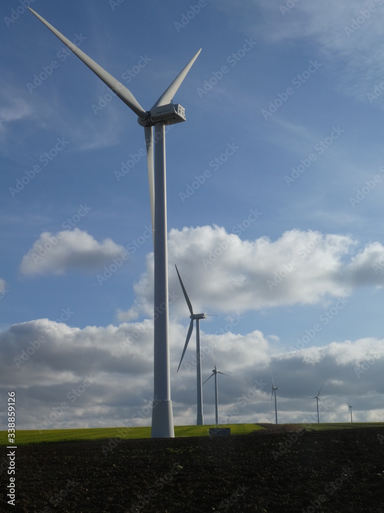 Row of six wind turbines in a field in France Row of six wind turbines in a field in France
