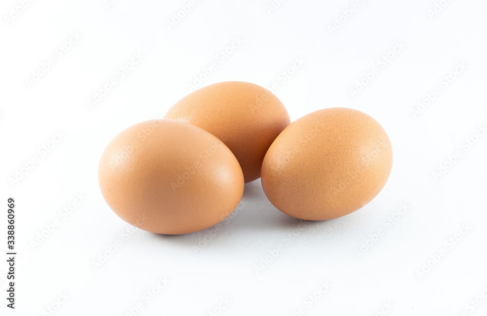 Close up of three organic raw brown chicken eggs isolated with white background Close up of three organic raw brown chicken eggs isolated with white background