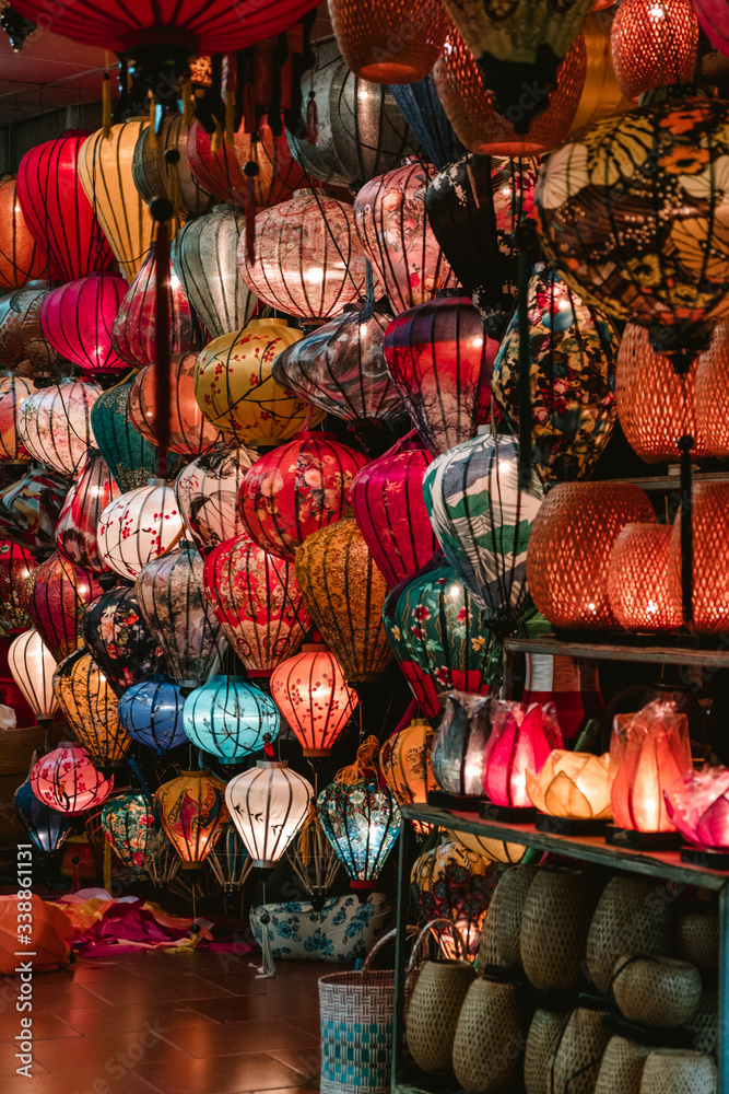 Colored lanterns hanging on a wall in a store in Hoi An, Vietnam. City of lights
