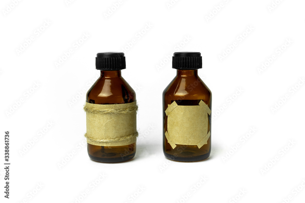 Two blank brown vintage Glass Medical Bottles with blank labels Isolated on White Background. 