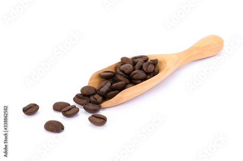 Closeup coffee bean in wooden scoop isolated on white background. 