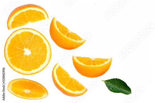 Closeup slice of ripe fresh orange fruit with green leaf isolated on white background. Top view. Flat lay.