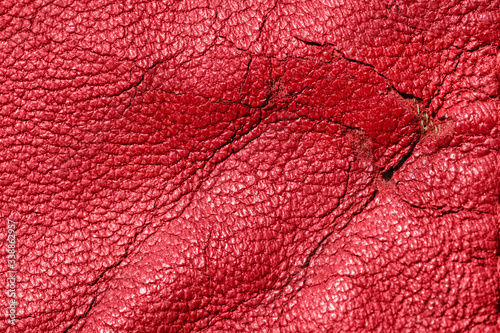 Obraz na plátně Shabby and worn red faux leather texture background with cracks and damages