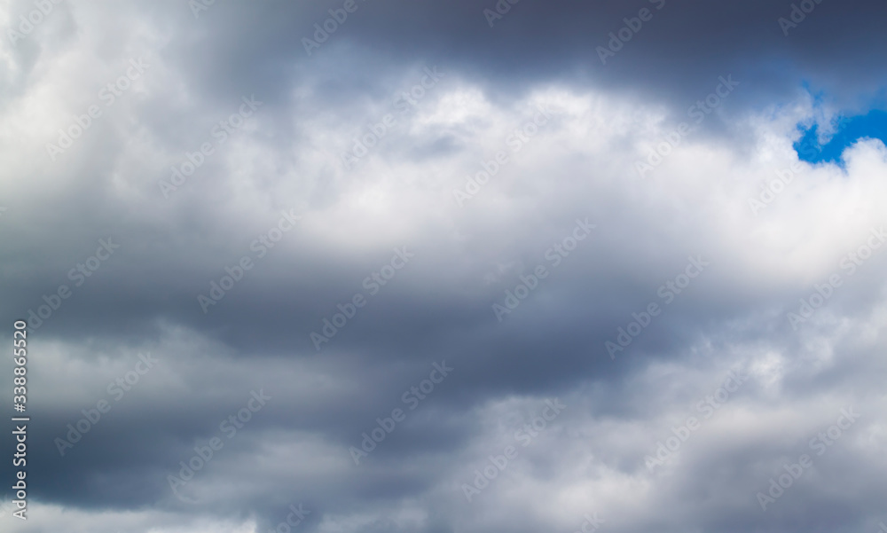 Fototapeta premium stormy grey and white clouds on blue sky background