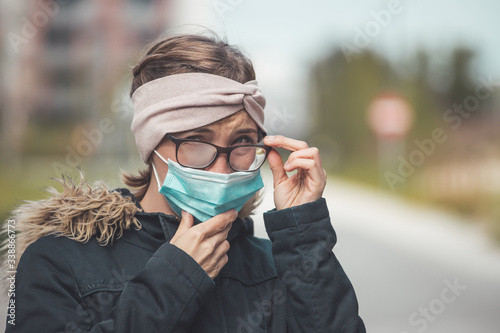 Bilde på lerret Woman with facemask and tarnished glasses, corona concept