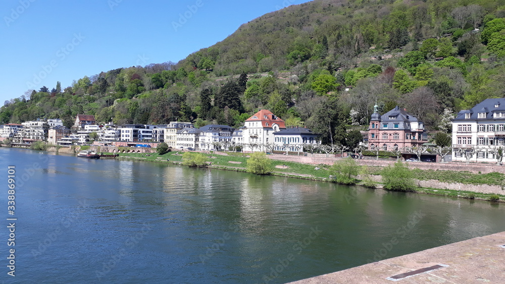 panoramic view of a river crosing a city surrounded by mountains