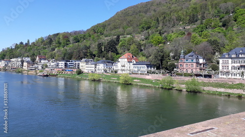 panoramic view of a river crosing a city surrounded by mountains © Adrian