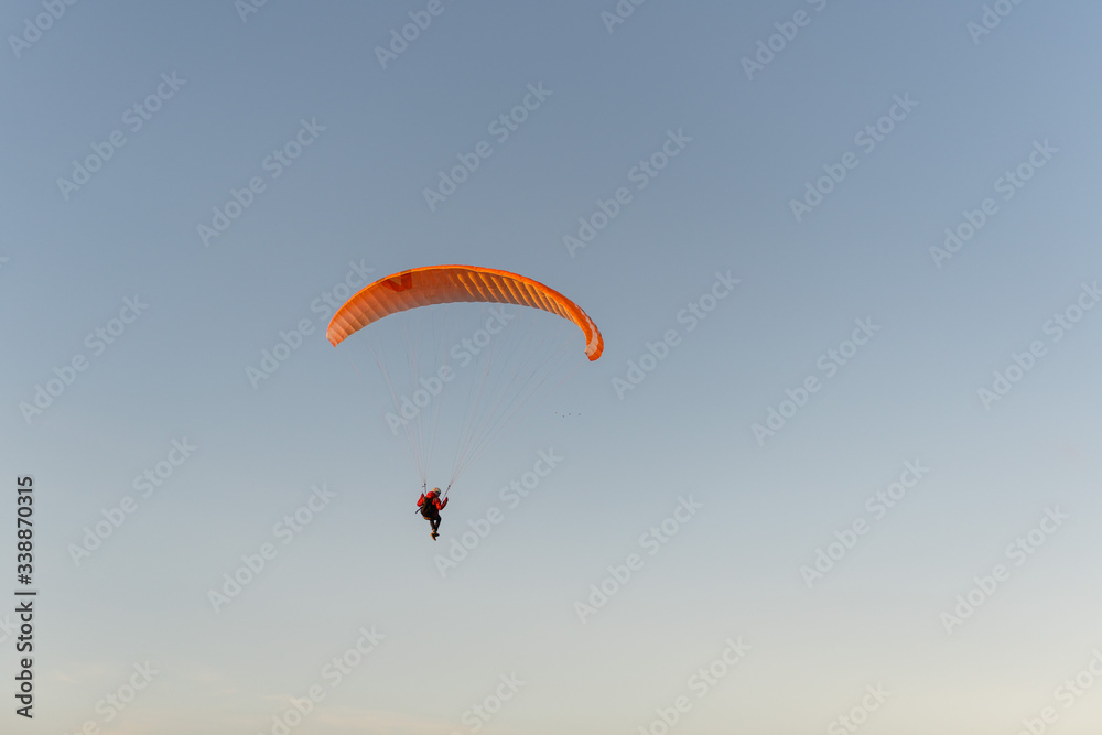 Paraglider flying over thesea shore at sunset. Paragliding sport concept. Paraglider flying over thesea shore at sunset. Paragliding sport concept.
