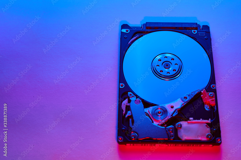 Disassembled hard drive from the computer, hdd with neon light. Opened hard  drive Part of computer or laptop Stock Photo | Adobe Stock