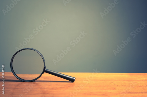 Magnifying Glass on Wood Table photo