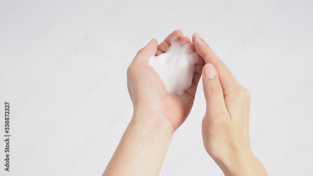 Hands washing gesture with foaming hand soap on white background. Hands washing gesture with foaming hand soap on white background.