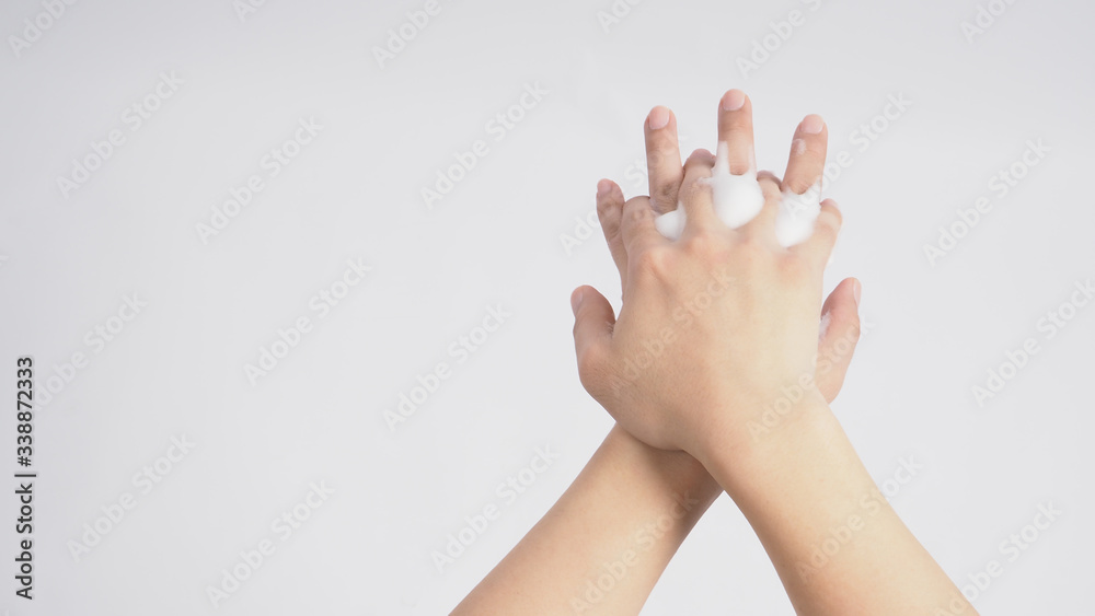 Male model is rub backs of both hands with foaming hand soap on white background. Male model is rub backs of both hands with foaming hand soap on white background.