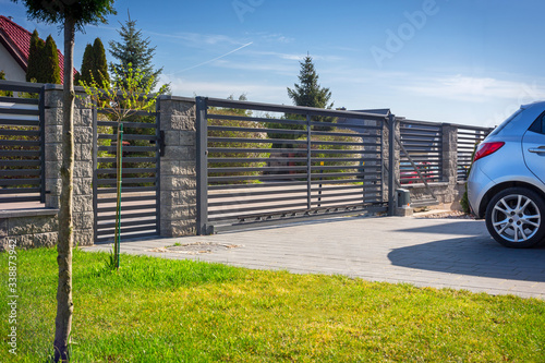 Stone fence and entrance gate with remote control photo