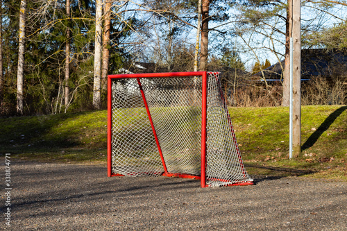 Red road hockey net on children playground in Finland photo