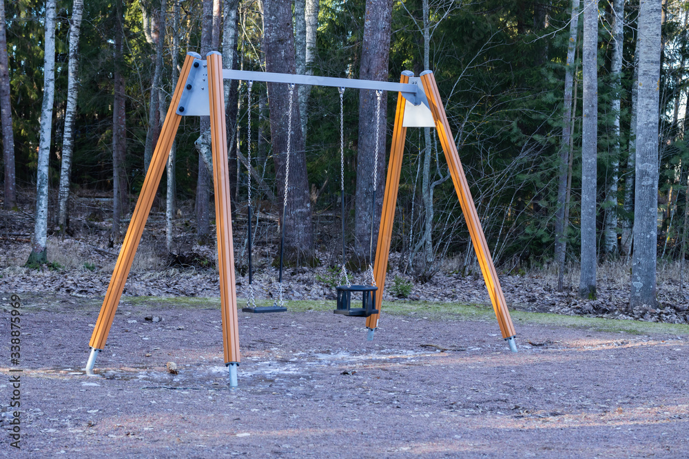 Swing on the empty playground in February, Finland Swing on the empty playground in February, Finland