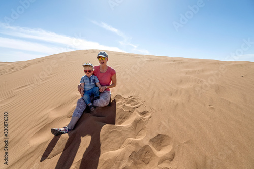 Wallpaper Mural Mother and her 2 years old son enjoying sitting on Sahara sand dunes, Africa Torontodigital.ca