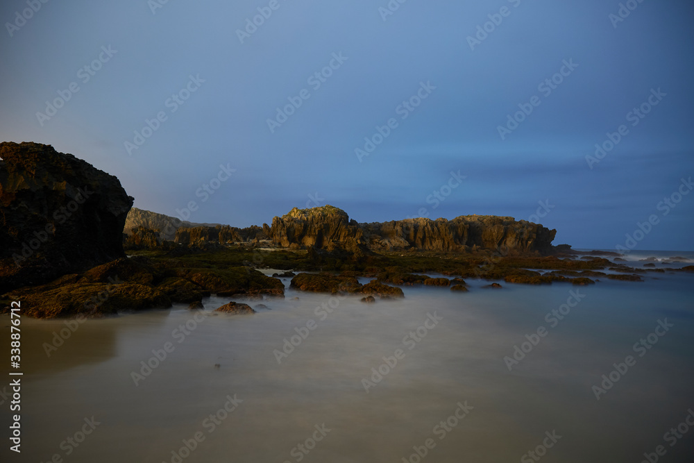 Landscape of rocks and cliffs in nature in the town of Noja made at night at low tide, Cantabria, Spain.