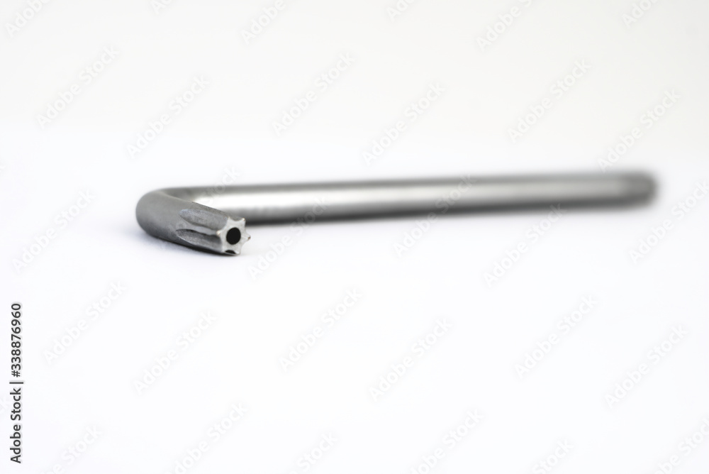 Metal torx on a white background. The drive is star, as in star screwdriver or star bits Metal torx on a white background. The drive is star, as in star screwdriver or star bits