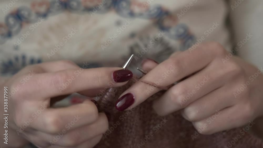 The girl is bored in quarantine and knits a warm sweater from wool