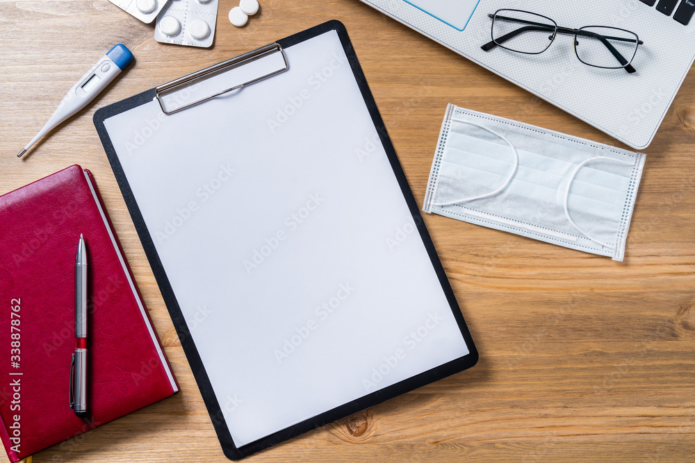 Flatlay doctor workplace with mask and with notepad mock up Flatlay doctor workplace with mask and with notepad mock up