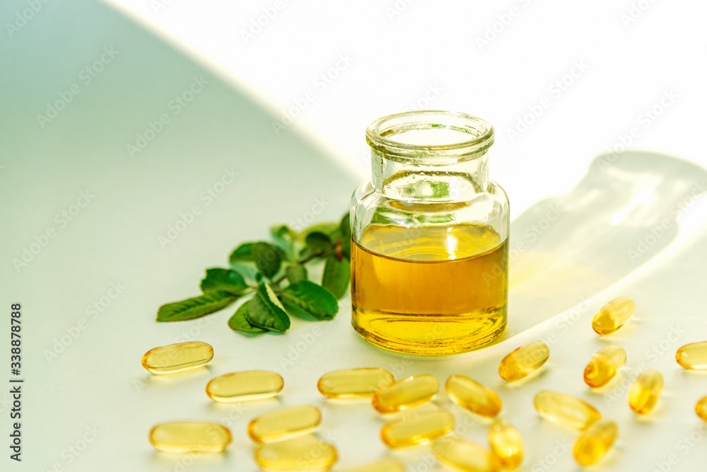 Natural Omega 3 vitamins, fish oil in glass jar and capsules on white background, close up