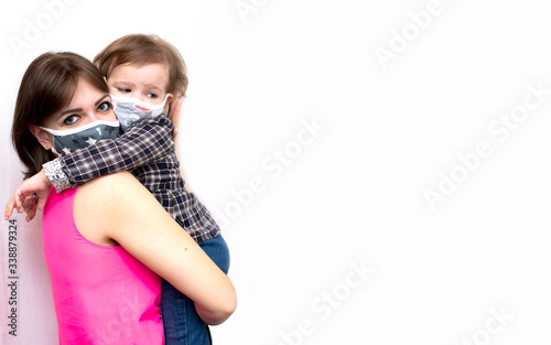 Mom and daughter in masks against the virus, coronavirus on a white background