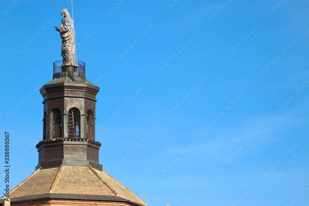 Statue on the top of Guadix cathedral bell tower, Spain