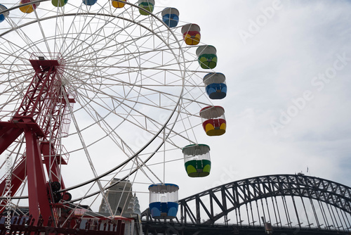 Sydney, NSW - November 28 2019: The Carousel in Luna Park with the Sydney Harbor Bridge in the front a popular tourist destination photo