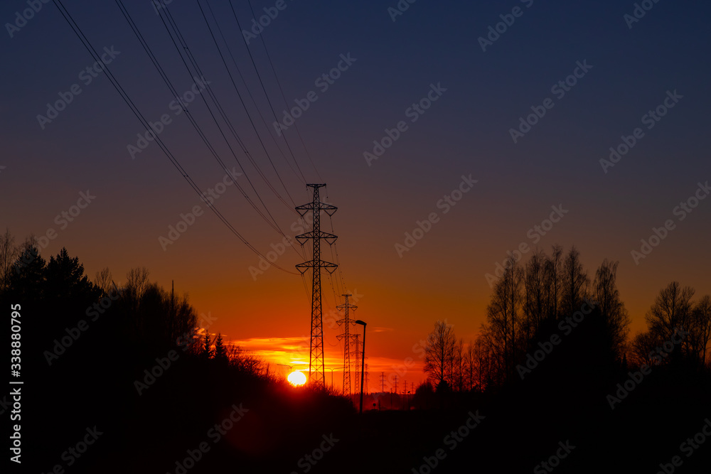 Fototapeta premium High voltage towers aganist the beautiful sunset